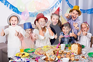 children having celebration of friend birthday during dinner