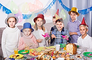 Children having celebration of friendâ€™s birthday during dinner