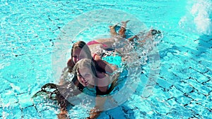 Children having fun beach resort in swimming pool with wave