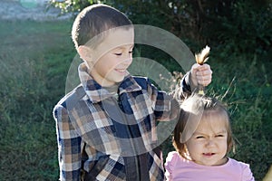 Children having fun. Boy and little girl portrait. Happy smiling children outdoors at sunny day. Friendship siblings