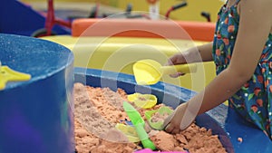 children having fun on entertainment center inflatable castle playing kinetic sand in quarantine