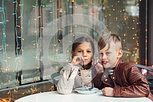 Children having fun in outdoor cafe photo