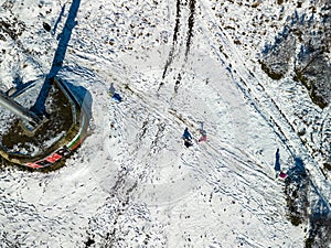 children having fun riding ice slide in winter Burgas,Bulgaria