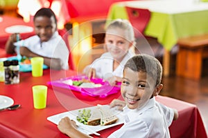 Children having lunch during break time in school cafeteria