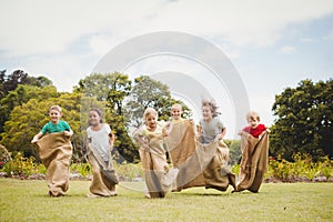 Children having a sack race in park photo