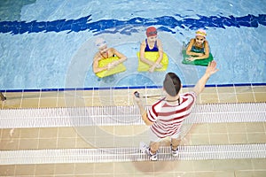 Children having swimming lesson