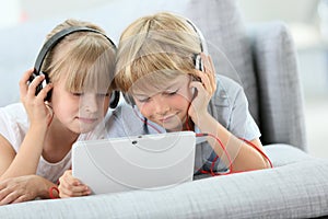 Children with headphones listening to music