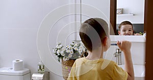 Children daily healthcare routine. Cute Caucasian Child with white Tooth looking at mirror isolated at home. Lifestyle