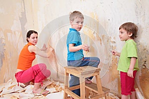 Children help mother remove old wallpapers from wa photo