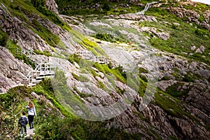 Children hiking along wooden boardwalks on the Battery Road trail at Signal Hill St. John\'s Newfoundland Canada