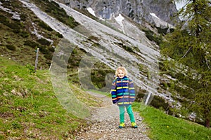 Children hiking in Alps mountains. Kids outdoor.