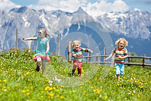 Children hiking in Alps mountains. Kids outdoor.