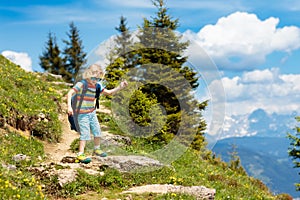 Children hiking in Alps mountains. Kids outdoor.