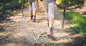 Children hiking in mountains or forest with sport hiking shoes.