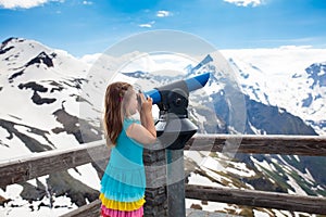 Children hiking in mountains. Kid with binoculars