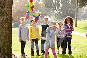 Children Hitting Pinata At Birthday Party