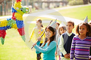 Children Hitting Pinata At Birthday Party