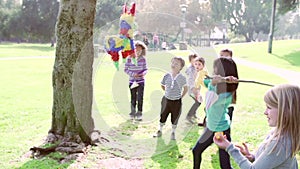 Children Hitting Pinata At Birthday Party In Slow Motion