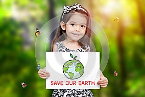 Children hold paper drawing Earth and green seedling growth and word save our Earth with green tree background and butterfly