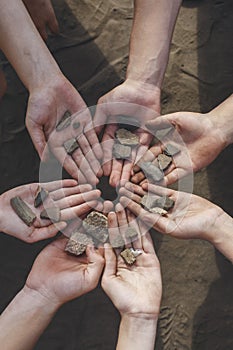 Children holding archaeological finds stones