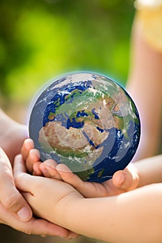 Children holding Earth in hands