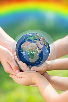 Children holding Earth in hands