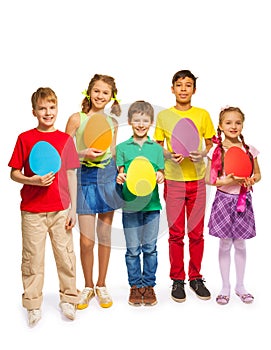 Children holding egg shape colourful cards