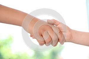 Children holding hands on blurred backgroun