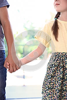 Children holding hands on blurred background