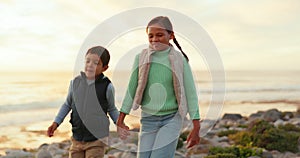 Children, holding hands and playing at beach for adventure, travel or holiday with energy and happiness. A young boy and