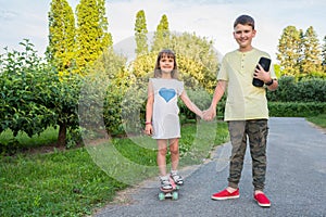 Children holding hands posing for the camera in a city park