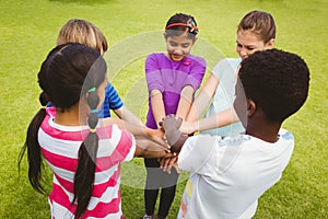 Children holding hands together at park