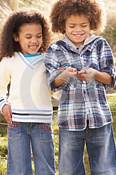 Children Holding Worm Outdoors