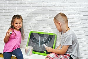 Children at home are engaged in primary education, learn to write on the blackboard .