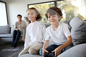 Children at home playing video games