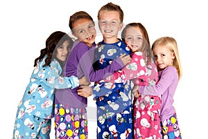 Children hugging in holiday christmas pajamas