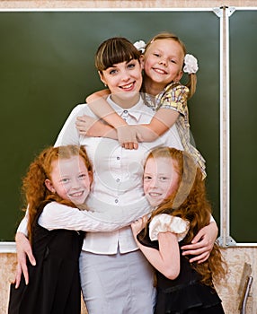 Children hugging their teacher