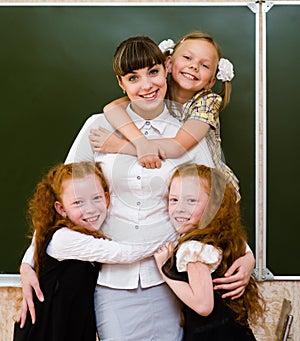 Children hugging their teacher