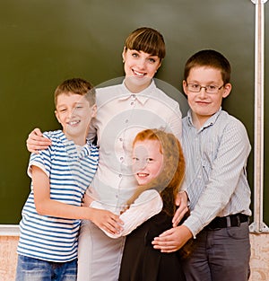 Children hugging their teacher