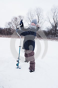 Children on ice fishing pose for the camera.