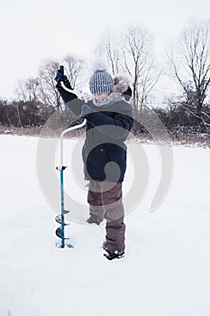 Children on ice fishing pose for the camera.