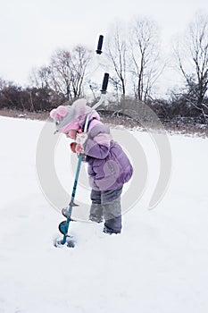 Children on ice fishing pose for the camera.