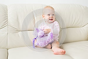 Children, infant and childhood concept - beautiful smiling baby sitting