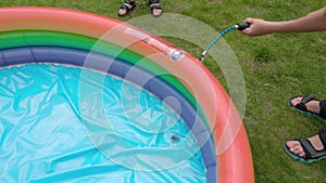 Children inflate a small pool with a pump