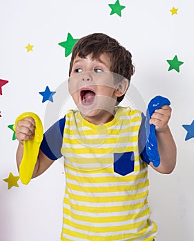 Children inflates a big bubble from a slime. Girl and boy play with slime.