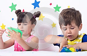 Children inflates a big bubble from a slime. Girl and boy play with slime.