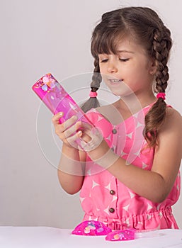 Children inflates a big bubble from a slime. Girl and boy play with slime.