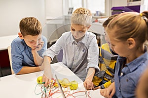 Children with invention kit at robotics school