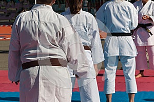 Children with Judo White Uniform doing Public Demonstration Outdoor on Tatami