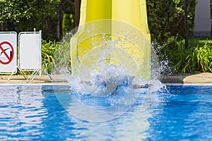 Children jump, swim and play in the pool on a beautiful sunny summer day.